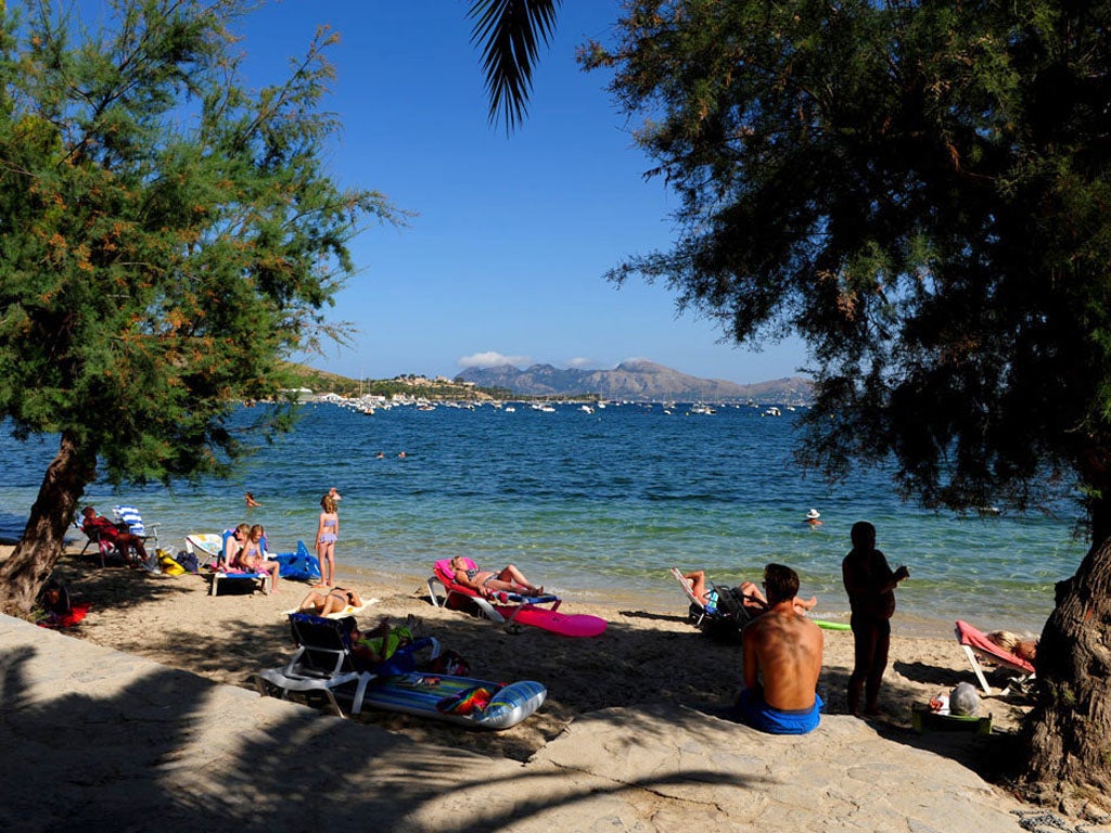 Money matters: Tourists relax in Mallorca. The euro has slumped in value this week, increasing the spending power of British travellers