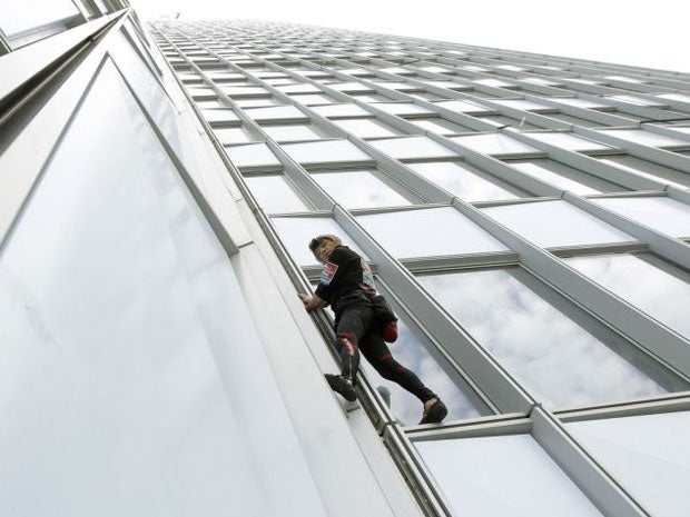 Alain Robert scales the First Tower at the La Defense business district outside Paris