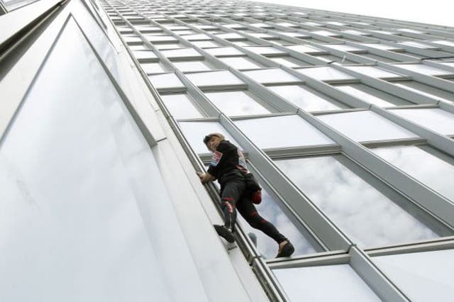 Alain Robert scales the First Tower at the La Defense business district outside Paris