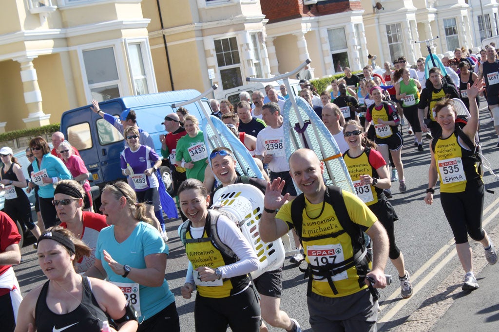 Phil Szomszor and his friends ran the Hastings Half Marathon with ironing boards strapped to their backs to raise money for St Michael's Hospice