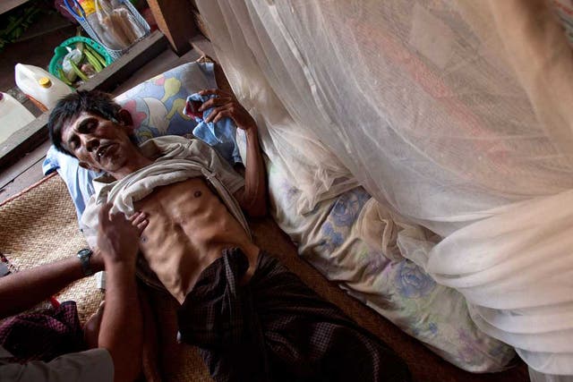 Powerless to resist: A TB patient is treated at his home in Yangon, Burma, which relies on foreign aid for about half its resources to fight the disease