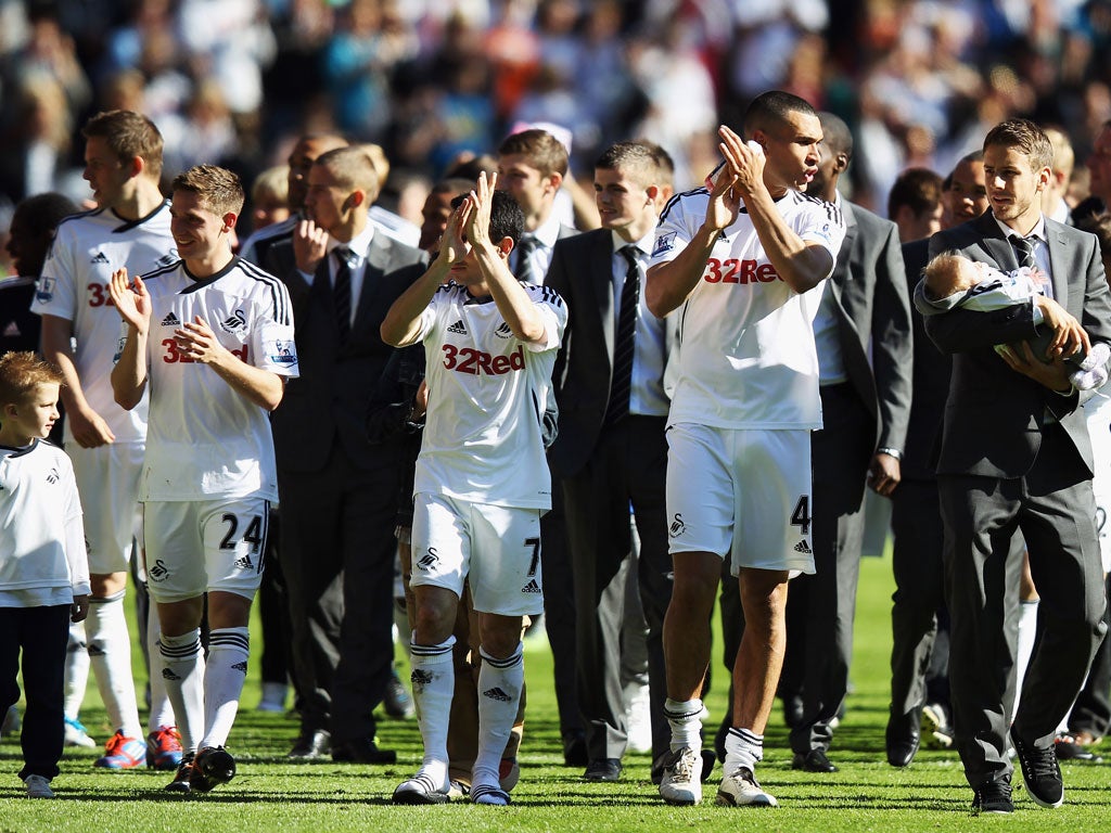 The Swansea team do a lap of honour after their 1-0 victory over Liverpool