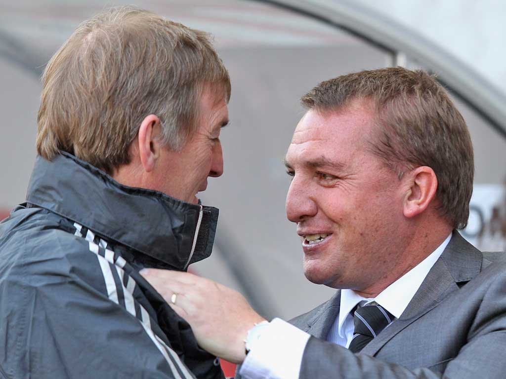 Brendan Rodgers (right) and Kenny Dalglish exchange words yesterday