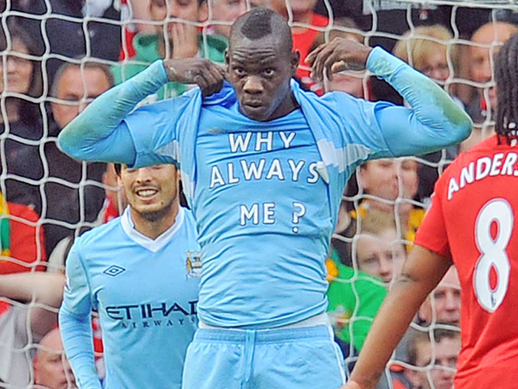 Italian fashion: Mario Balotelli reveals his ‘Why Always Me?’ T-shirt
after rolling in the first goal during City’s astonishing 6-1 victory at Old Trafford