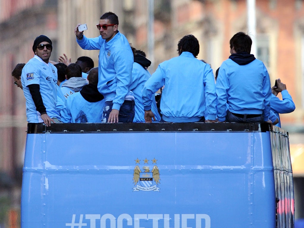 Tevez (left) pictured during City's victory parade