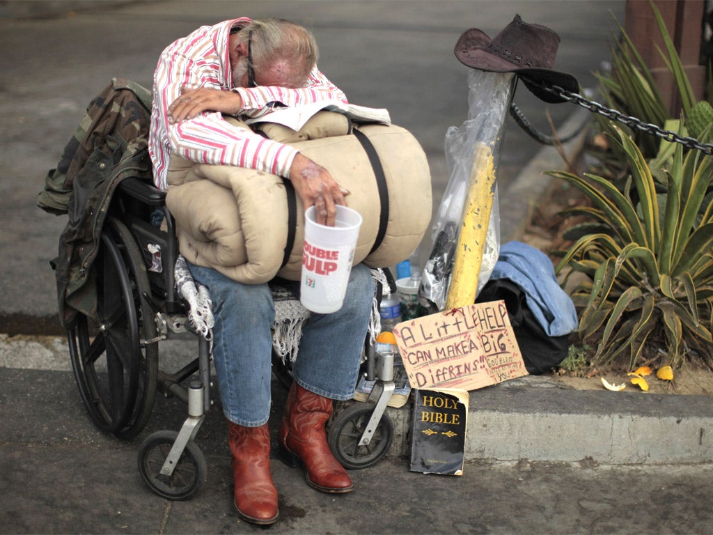 A homeless man in Los Angeles, California: the state is cutting healthcare and welfare payments and the Governor is calling for tax rises to avert disaster