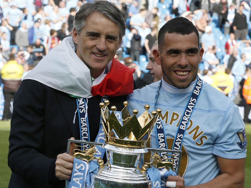 Carlos Tevez (right) and Roberto Mancini with the Premier League trophy