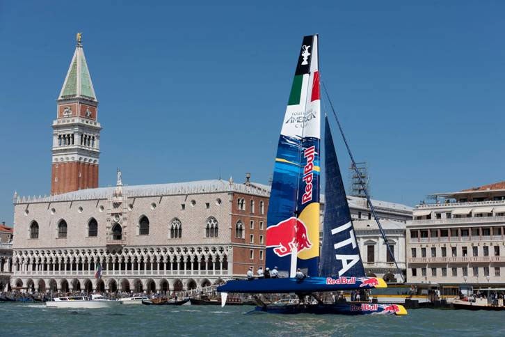 Giving youth a chance, the Red Bull catamaran takes to its wings with the famous waterside of Venice in the background to launch the Youth America’s Cup