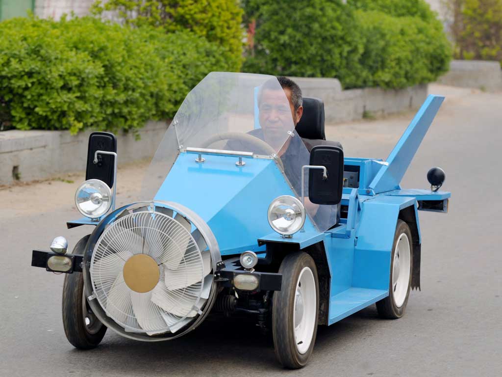 Chinese farmer Tang Zhenping has built, for a mere £1,000, the 'Blue Hornet' - an electric car made of scrap motorbike, scooter and car parts that's powered(ish) by wind