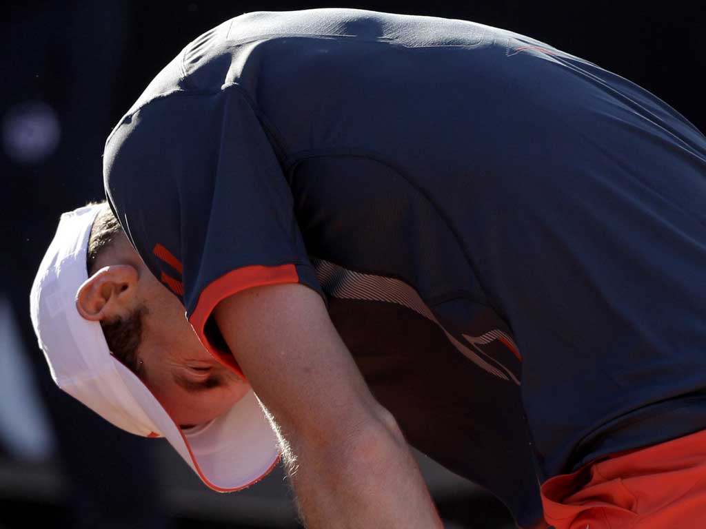 Andy Murray suffers with his back injury in Rome yesterday