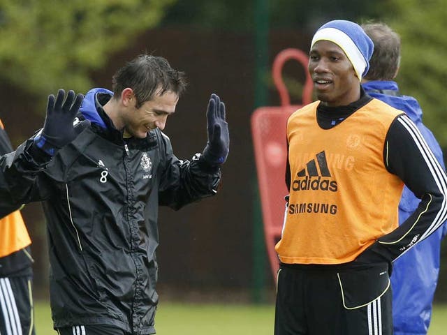Frank Lampard jokes with Didier Drogba during training for the Champions League final