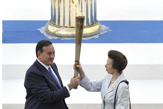 The Princess Royal is handed the Olympic torch