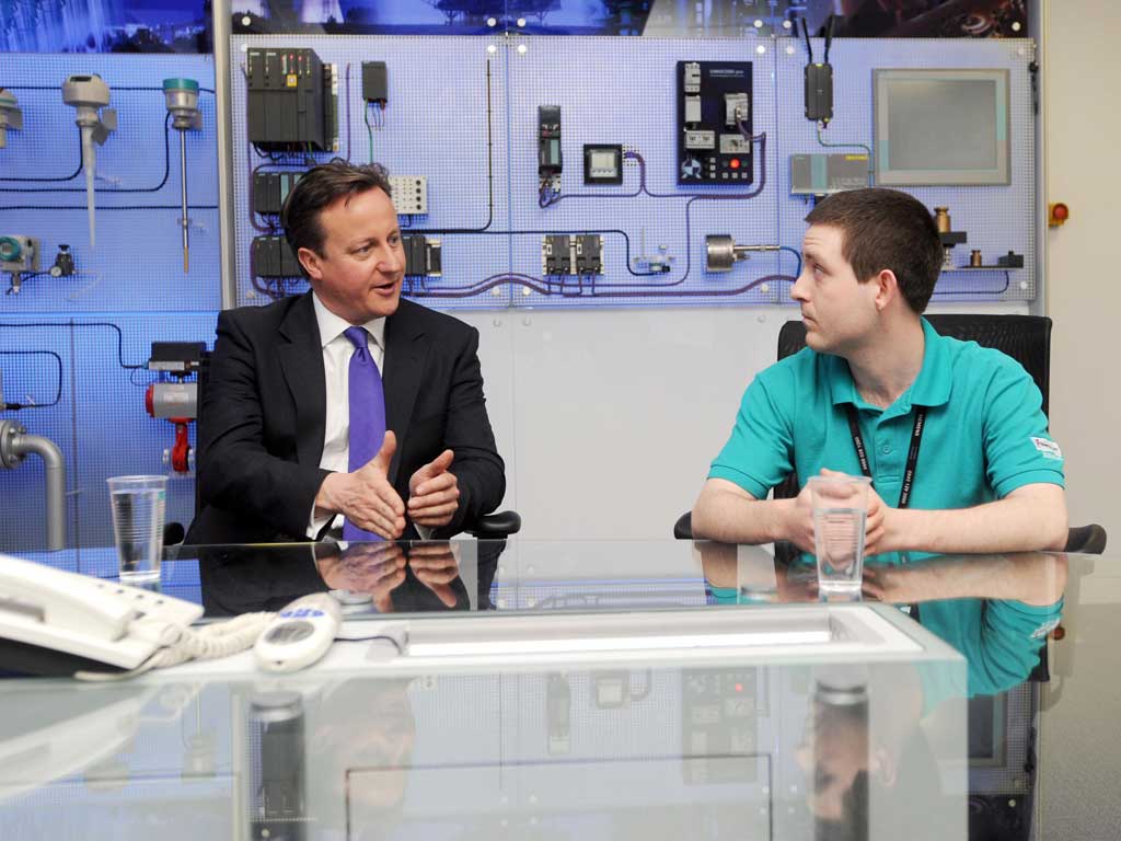 David Cameron meets apprentice James Yeoman during a visit to a Siemens plant in Manchester yesterday