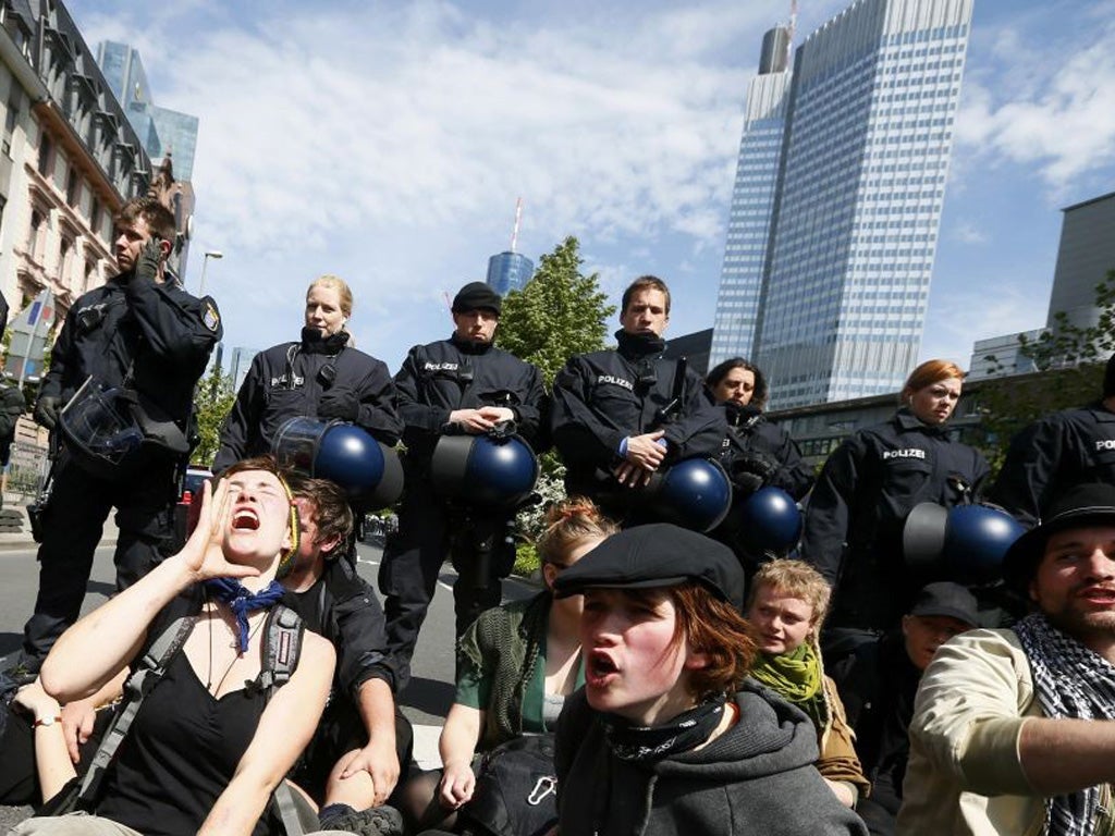 German riot police watch over an anti-austerity demonstration in Frankfurt yesterday