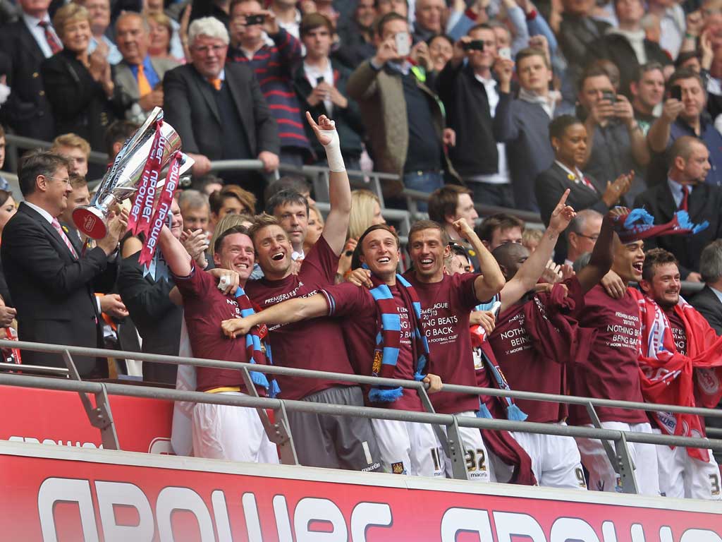 We've done it! Kevin Nolan lifts the trophy after West Ham win 2-1 in the Championship play-off final