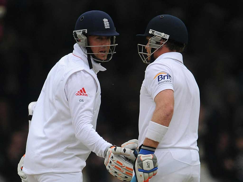 Bell's sound: England's Graeme Swann (left) congratulates Ian Bell for reaching his half-century against West Indies in the First Test at Lord's yesterday