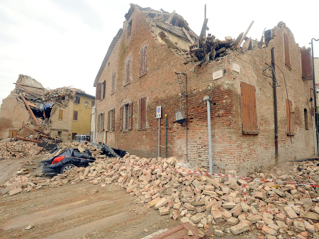 A house and car severely damaged in Ferrara, Italy following a magnitude-6.0 earthquake