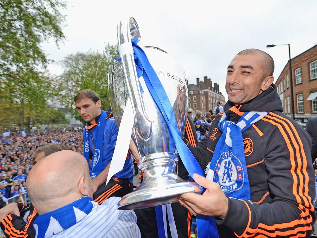 Manager Roberto Di Matteo lifts the Champions League trophy during the Chelsea victory parade