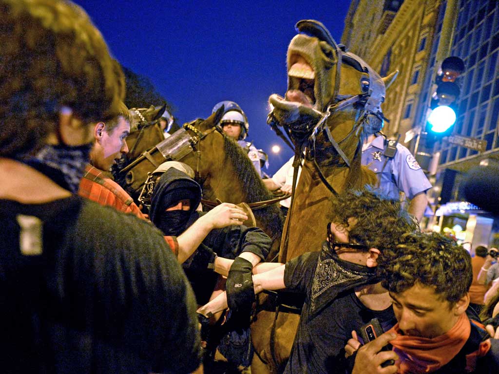 Protesters clash with mounted police during a march through Chicago before the Nato summit
