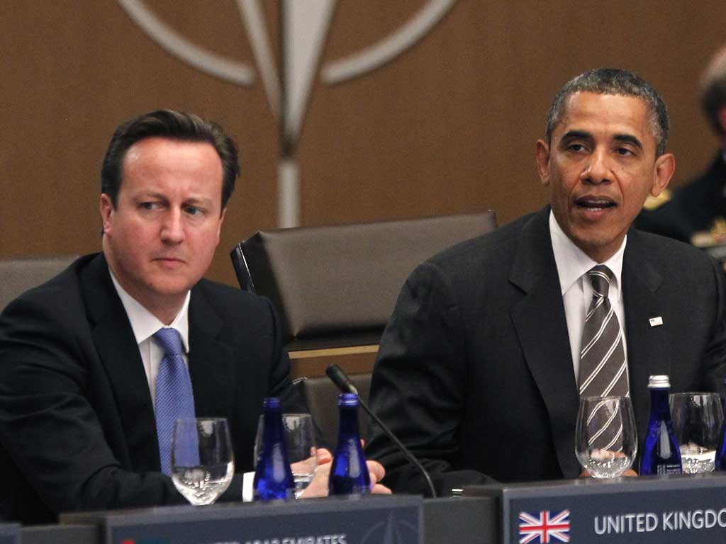 David Cameron listens as Barack Obama speaks at the Nato summit today