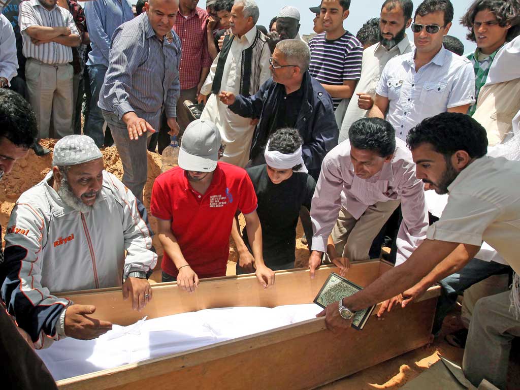 Mourners prepare to take Megrahi’s body for burial in Tripoli yesterday