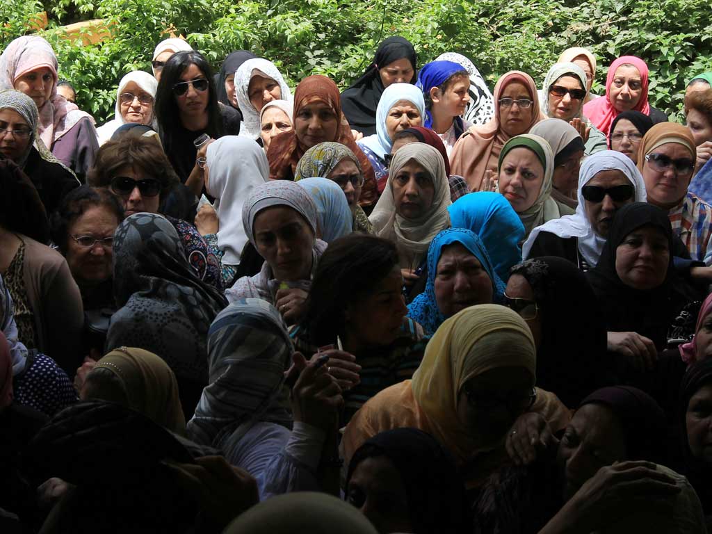 Egyptian women gather outside a polling station in Cairo today