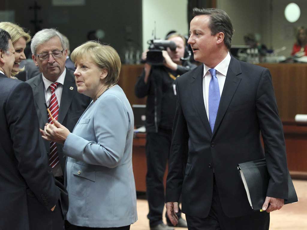 David Cameron walks past Jose Manuel Barroso, Helle Thorning-Schmidt, Jean-Claude Juncker and Angela Merkel during at last night's summit in Brussels
