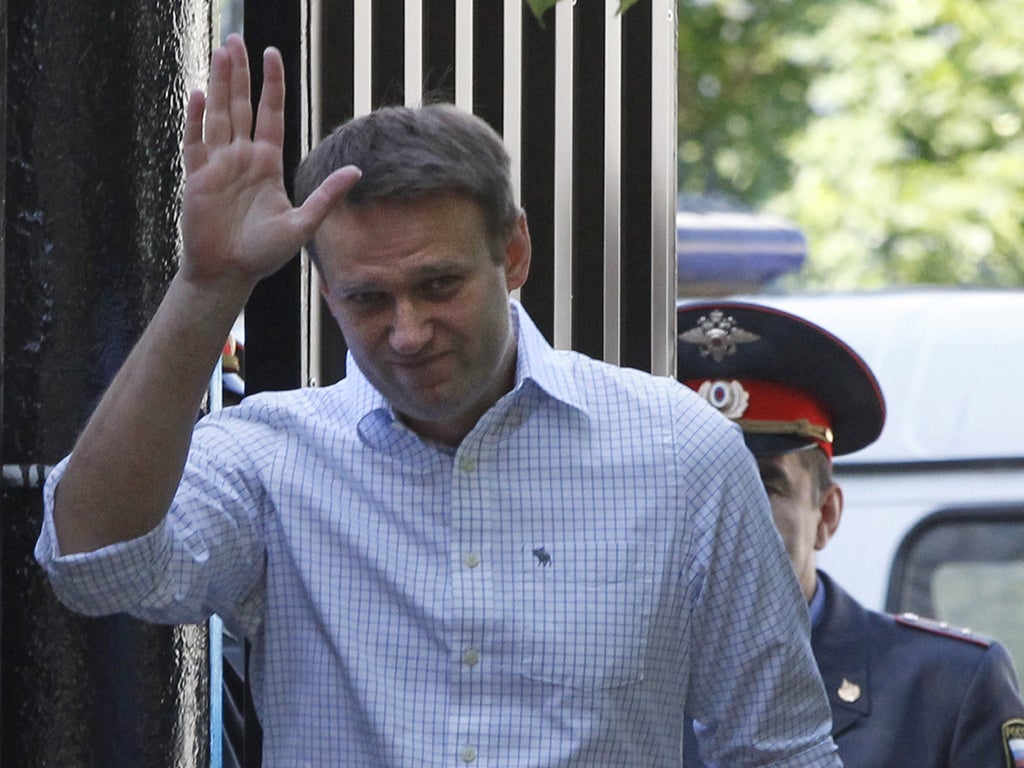 Alexei Navalny greets supporters after leaving a detention centre in Moscow yesterday
