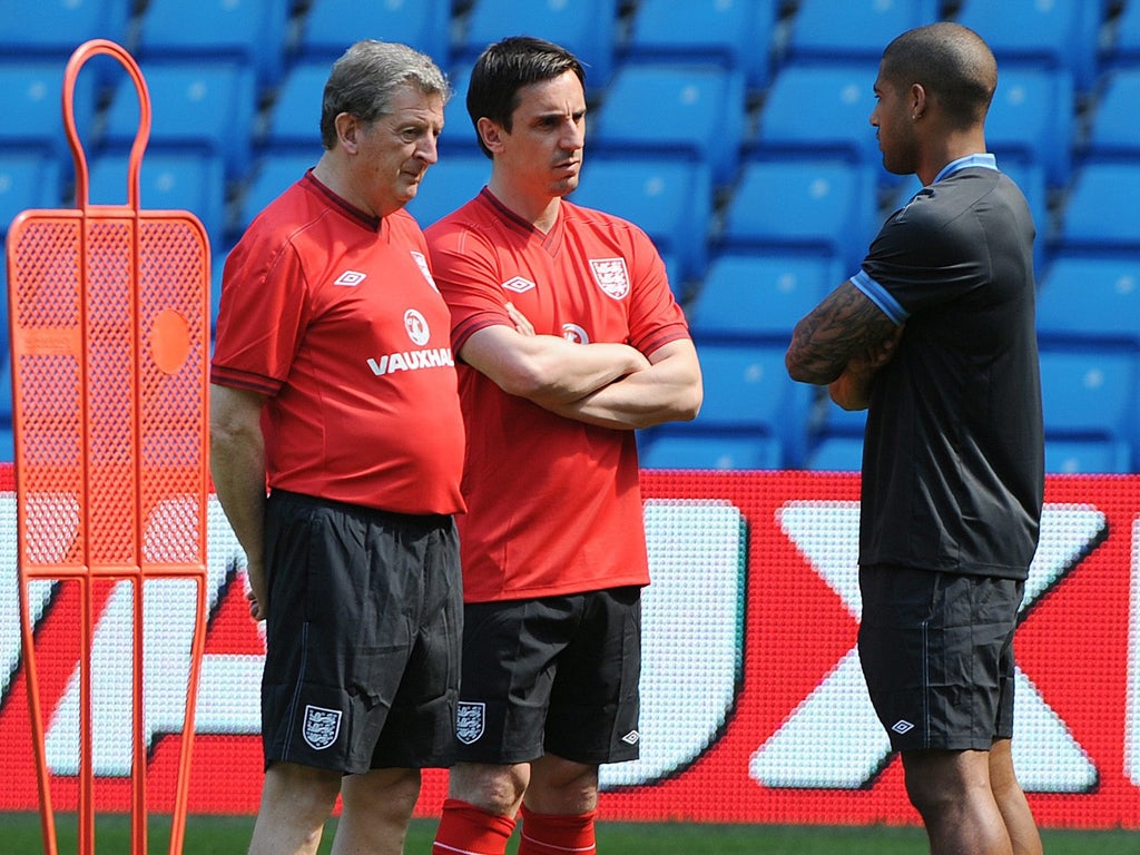 Roy Hodgson (left) and Gary Neville (centre) speak to Glen Johnson during an England training session atthe Etihad Stadium yesterday