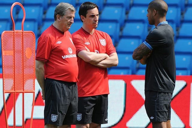 Roy Hodgson (left) and Gary Neville (centre) speak to Glen Johnson during an England training session atthe Etihad Stadium yesterday