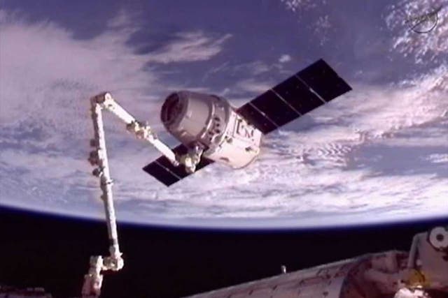 The SpaceX Dragon commercial cargo craft is moved into position for docking with the International Space Station using the station's Canadarm2
