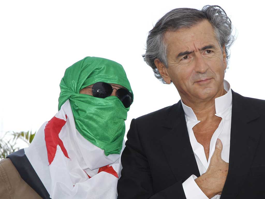 Levy and a Syrian dissident pose during the photocall for his new film Le Serment de Tobrouk
