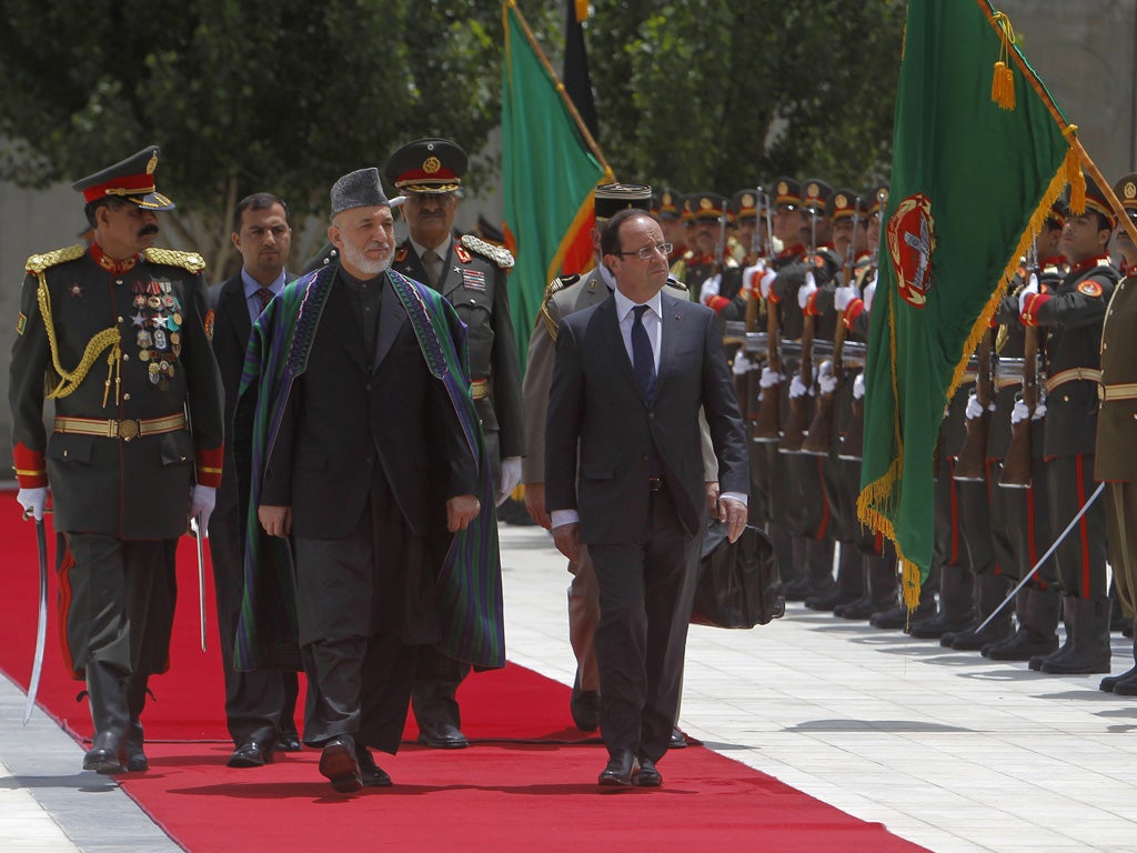 The French president François Hollande (right) with Afghan President Hamid Karzai