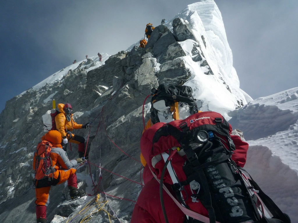 A line of climbers stretches upwards from Hillary Step, 90 metres
below Everest's peak