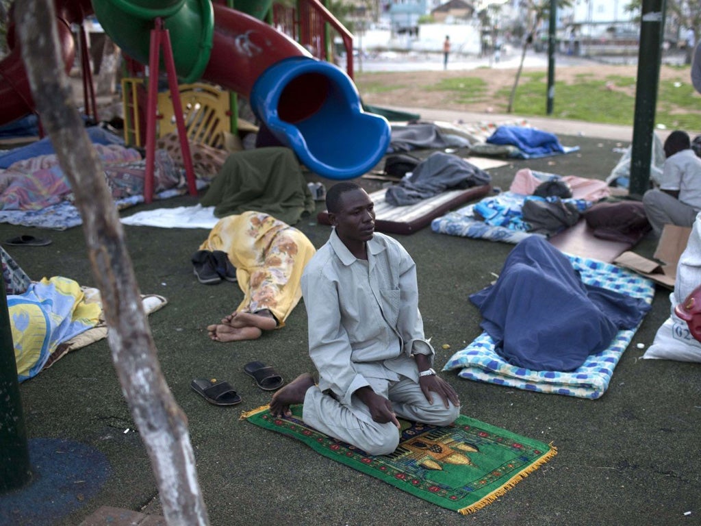 A Muslim African migrant prays as comrades sleep at a children's
playground in Levinsky Park, southern Tel Aviv, yesterday