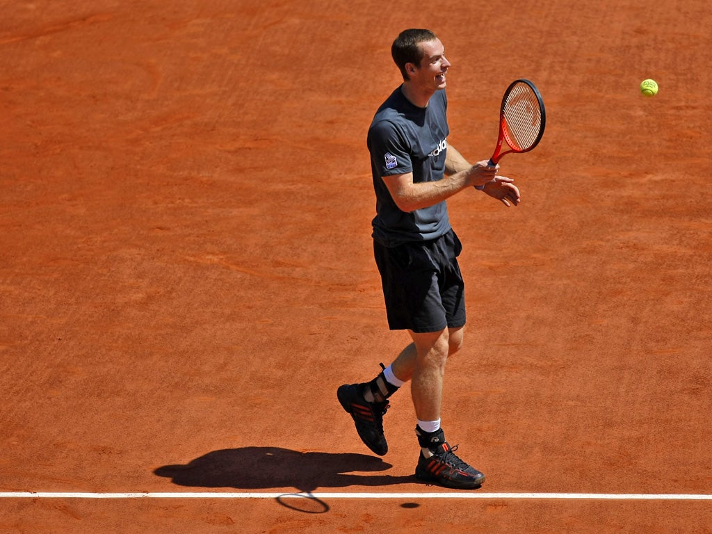 Andy Murray enjoys himself practising at Roland Garros yesterday