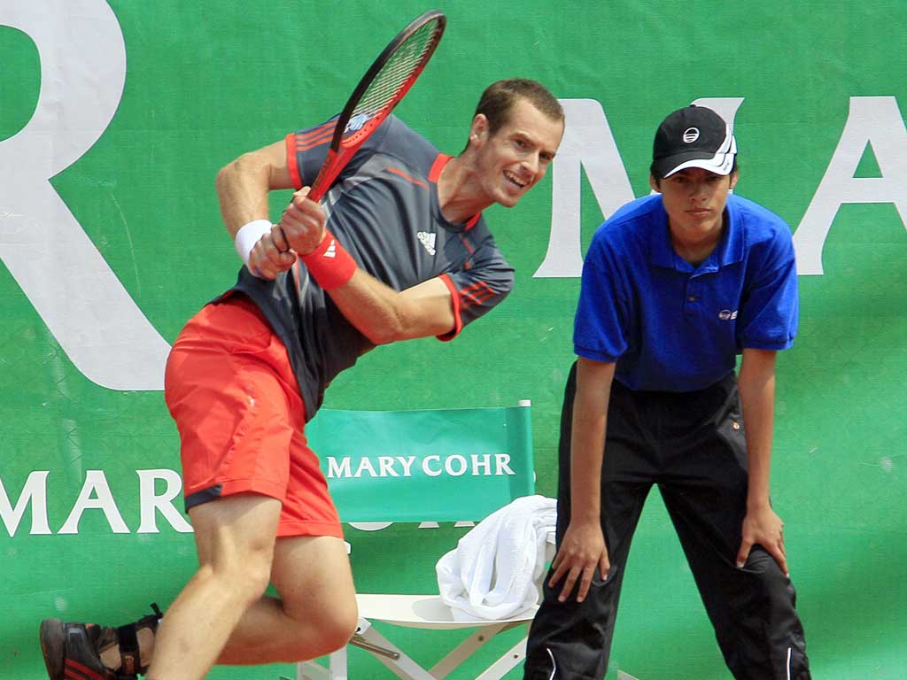 Back in action, 2012: Andy Murray keeps his eye on the ball in an exhibition match in Paris last week