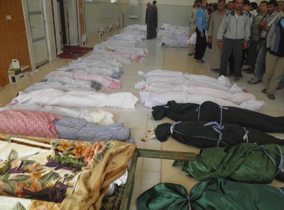 Victims of war: The bodies of people whom anti-government protesters say were killed by security forces in Houla, near Homs, yesterday