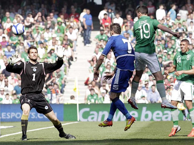 Towering presence: Shane Long scores with a header in Dublin to give the Republic a timely boost before Euro 2012