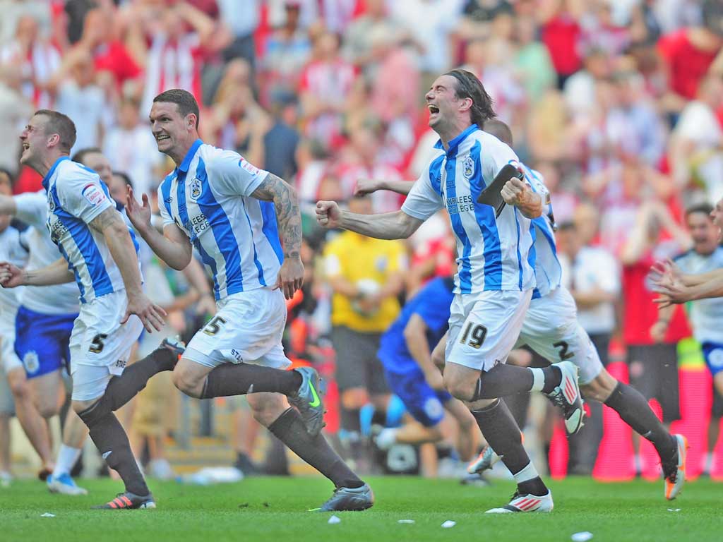 Huddersfield players celebrate at the end of the penalty shoot-out