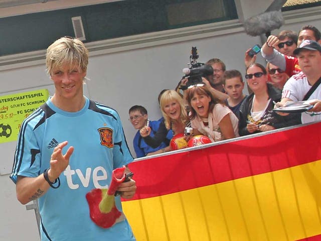 Fernando Torres is the centre of attention as he leaves a Spain
training session in Schruns in Austria yesterday