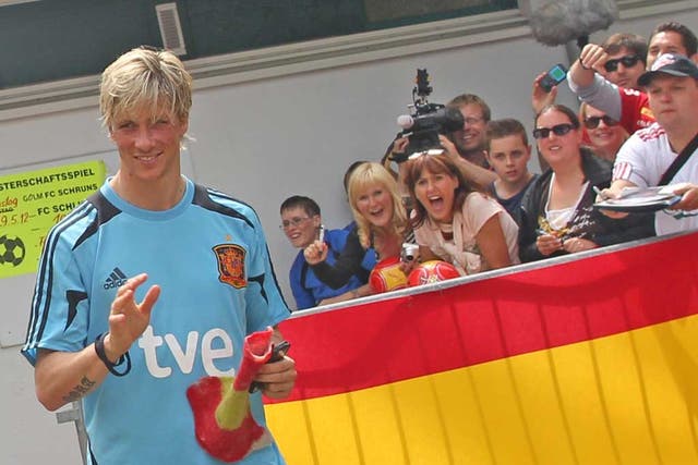 Fernando Torres is the centre of attention as he leaves a Spain
training session in Schruns in Austria yesterday