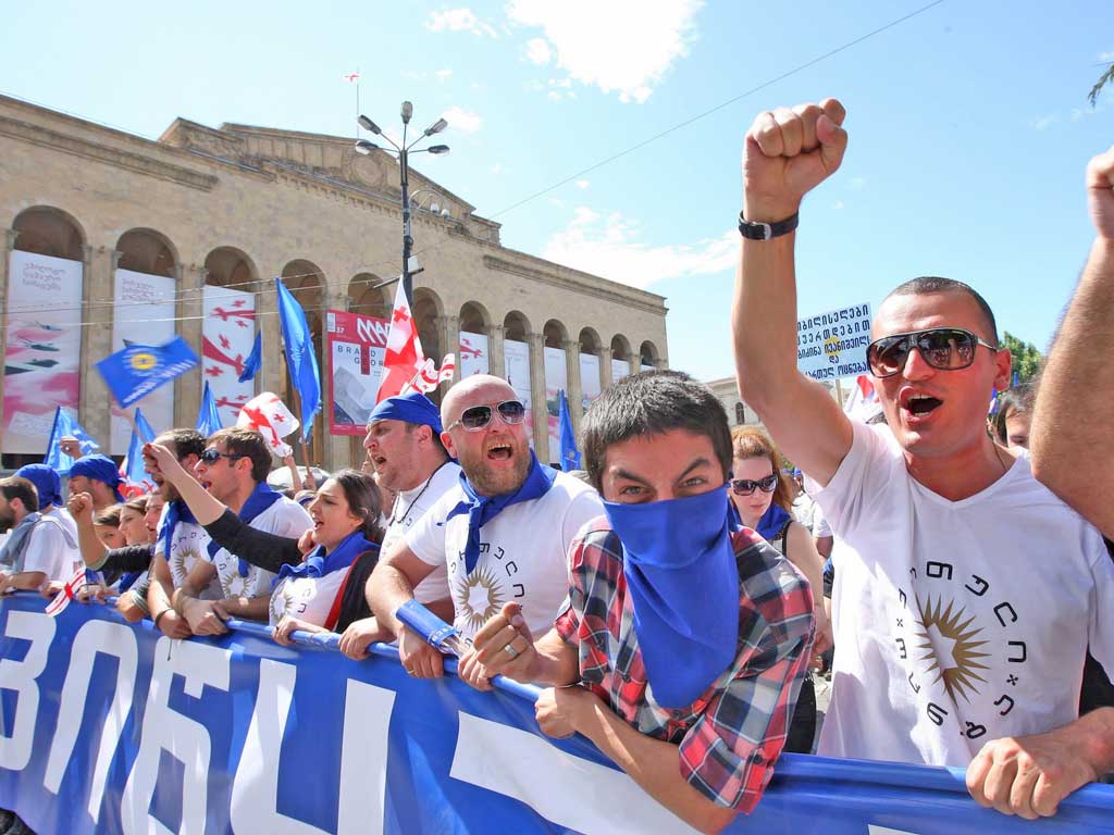 People shout slogans during a rally supported by billionaire Bidzina Ivanishvili against Georgian President, Mikhail Saakashvili, in the capital, Tbilisi
