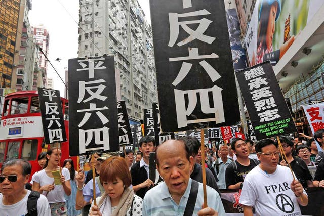Protesters show placards that read ‘Exonerate the June 4’ during a rally in Hong Kong ahead of the 23rd anniversary of the military crackdown on the pro-democracy movement in Beijing