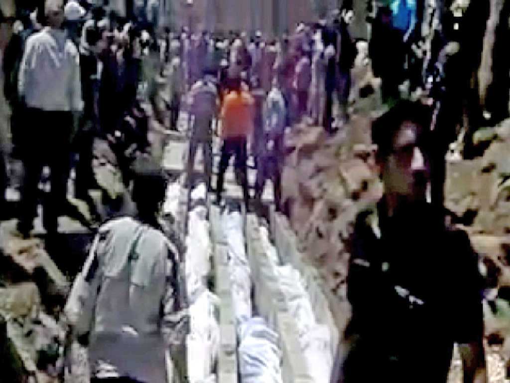 Video published on the internet shows bodies being prepared
in Houla for a mass funeral