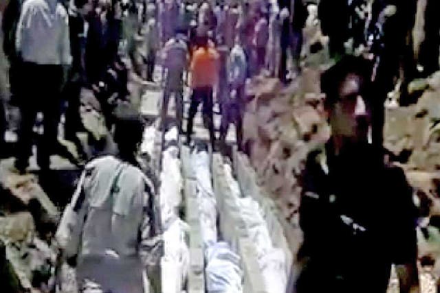 Video published on the internet shows bodies being prepared
in Houla for a mass funeral