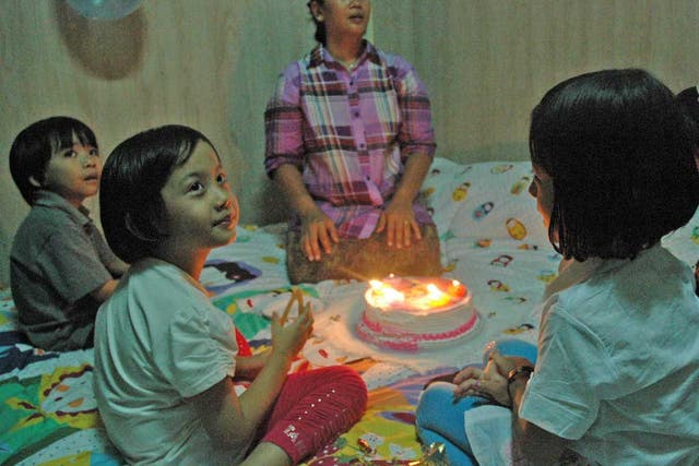 A prisoner for almost 20 years, Nilar Thein seems stunned she
can celebrate her daughter’s fifth birthday