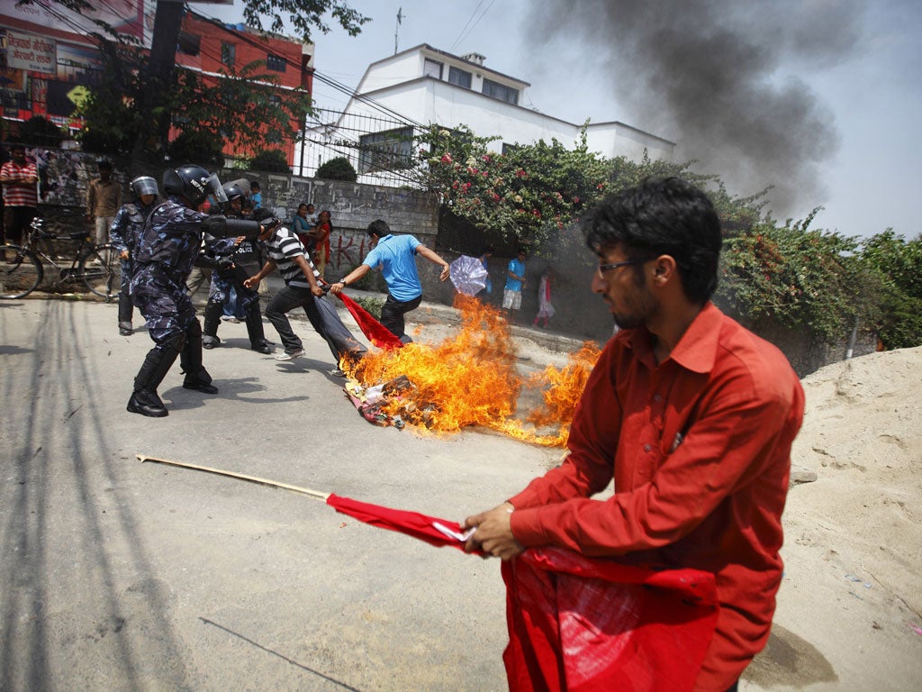 Students burn an effigy of the Nepalese Prime Minister Baburam Bhattarai in Kathmandu yesterday, demanding his immediate resignation
