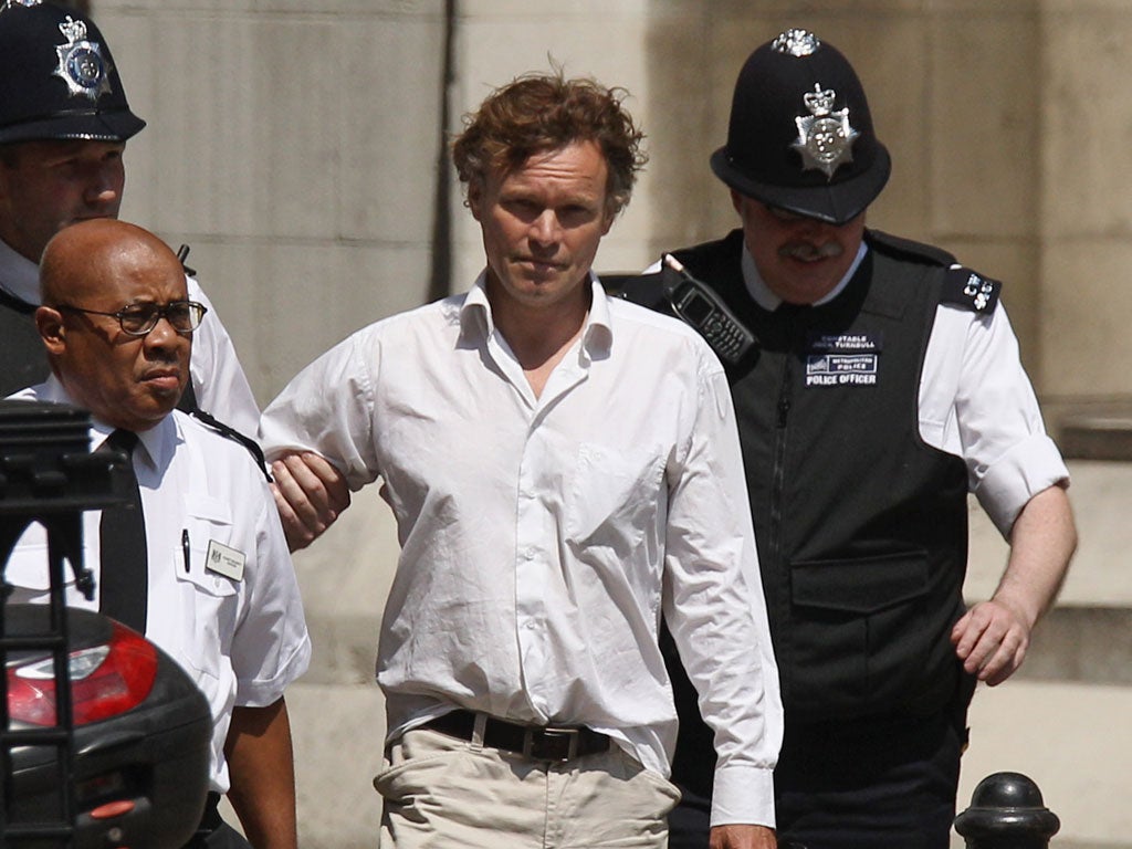 David Lawley-Wakelin, who disrupted Tony Blair’s testimony at the Leveson Inquiry by bursting into the court
and accusing him of war crimes, is led away from the Royal Courts of Justice by police and security staff