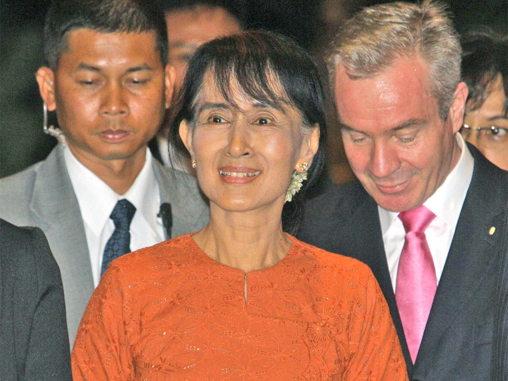Aung San Suu Kyi arrives at a hotel in Bangkok yesterday